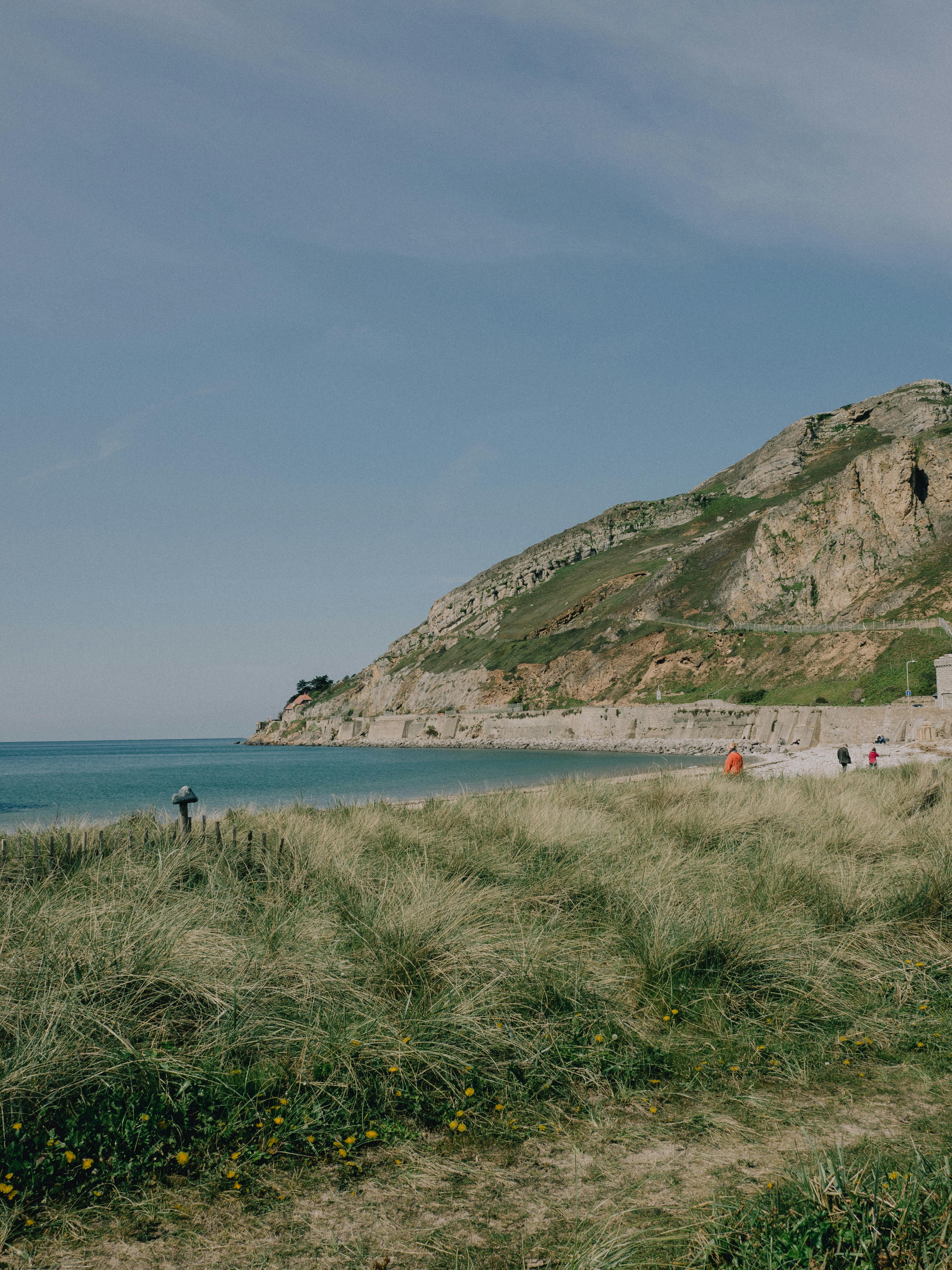 Explore the serene blend of coastline and hills at West Shore Beach in Llandudno, Wales.