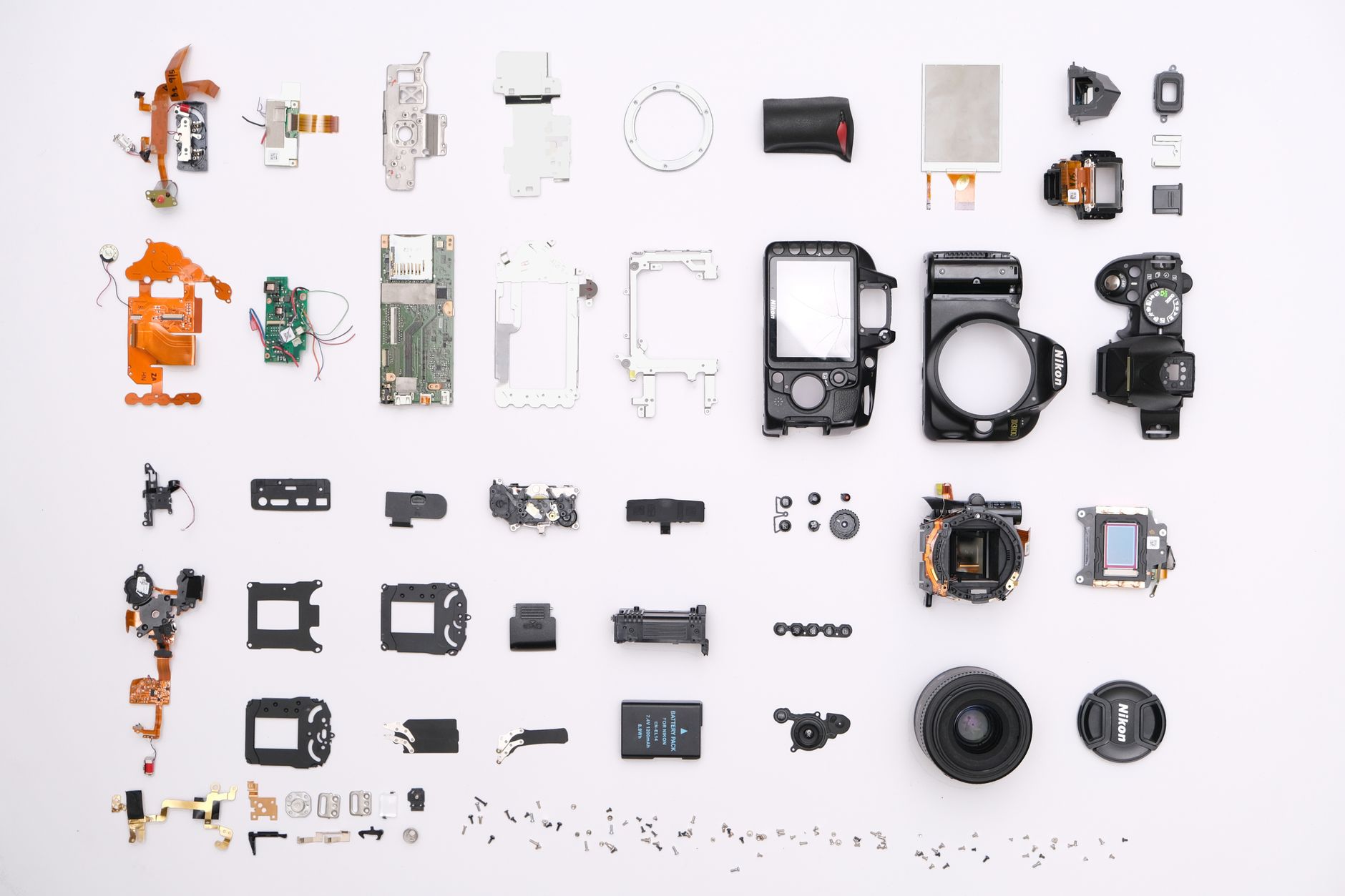 A detailed flat lay of disassembled camera components showcasing intricate electronics.
