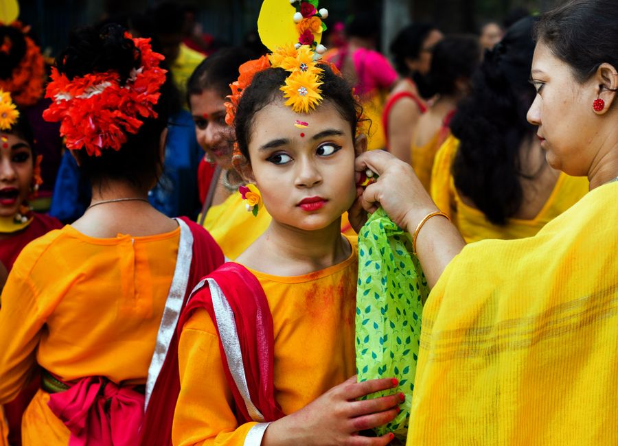 Vibrant traditional festival with girls in colorful attire, showcasing cultural heritage.