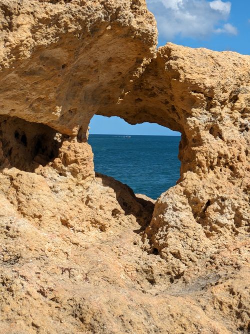 Free Stunning natural rock arch on Algarve coast framing a breathtaking ocean view. Stock Photo