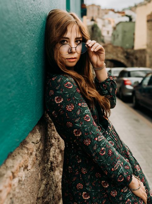Portrait of a stylish woman posing against a colorful wall in Guanajuato, Mexico.