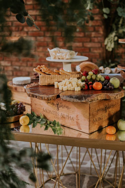 A table with fruit, cheese and crackers