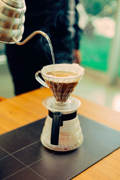 Free A Person Pouring Hot Water into a Filter Coffee Maker  Stock Photo