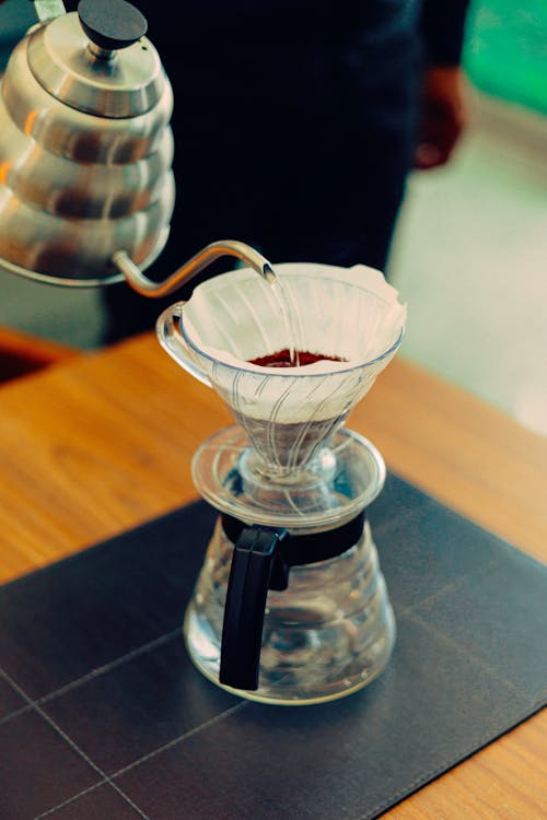 Free A Person Pouring Hot Water into a Filter Coffee Maker  Stock Photo