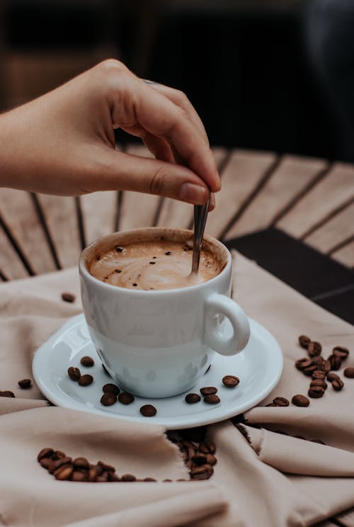 Close-up of a Person Stirring the Coffee 