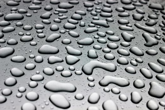 High-quality macro image of water droplets on a black glass pane, creating a textured abstract pattern.. pexels, high, qualit