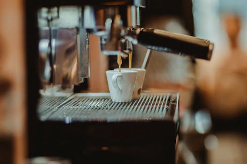 A coffee machine is being used to make coffee