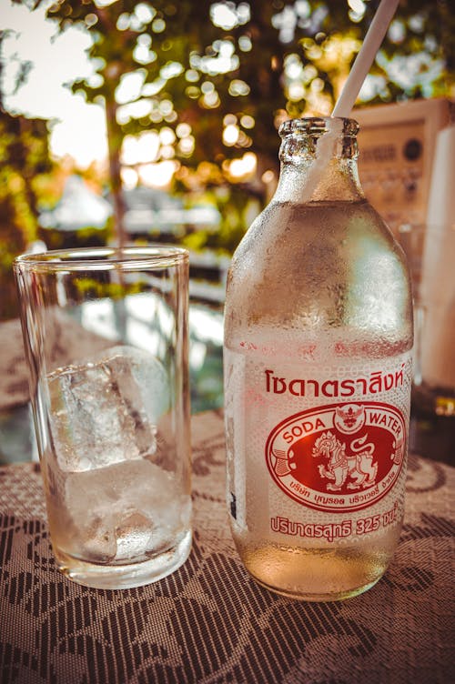 Free Photo of Drinking Glass Beside Bottle Stock Photo