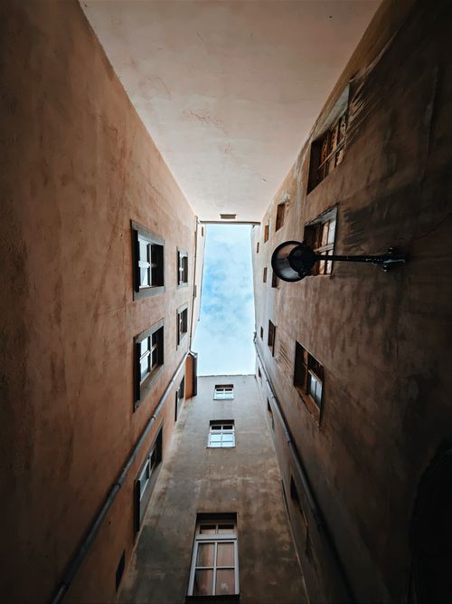 Free A unique upward view of an urban courtyard alley in Zittau, Germany. Stock Photo