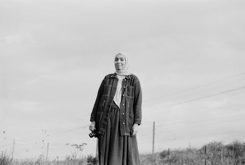 Free A woman in a hijab standing in a field Stock Photo
