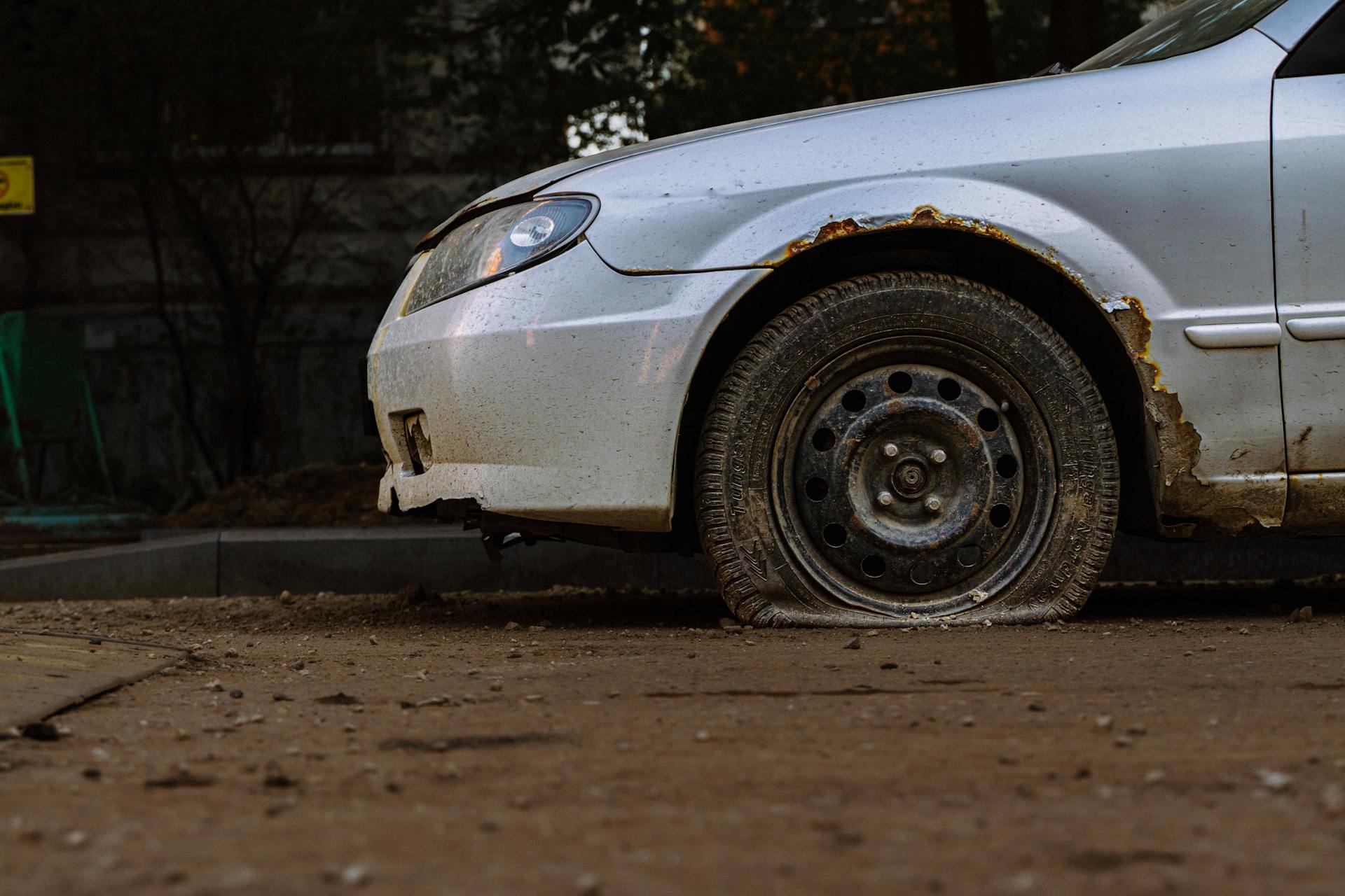 Abandoned Car with Flat Tire