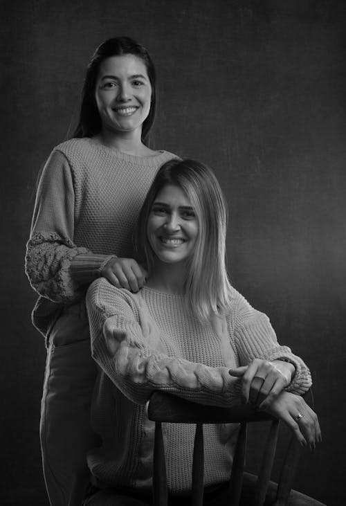 Two women posing for a black and white photo