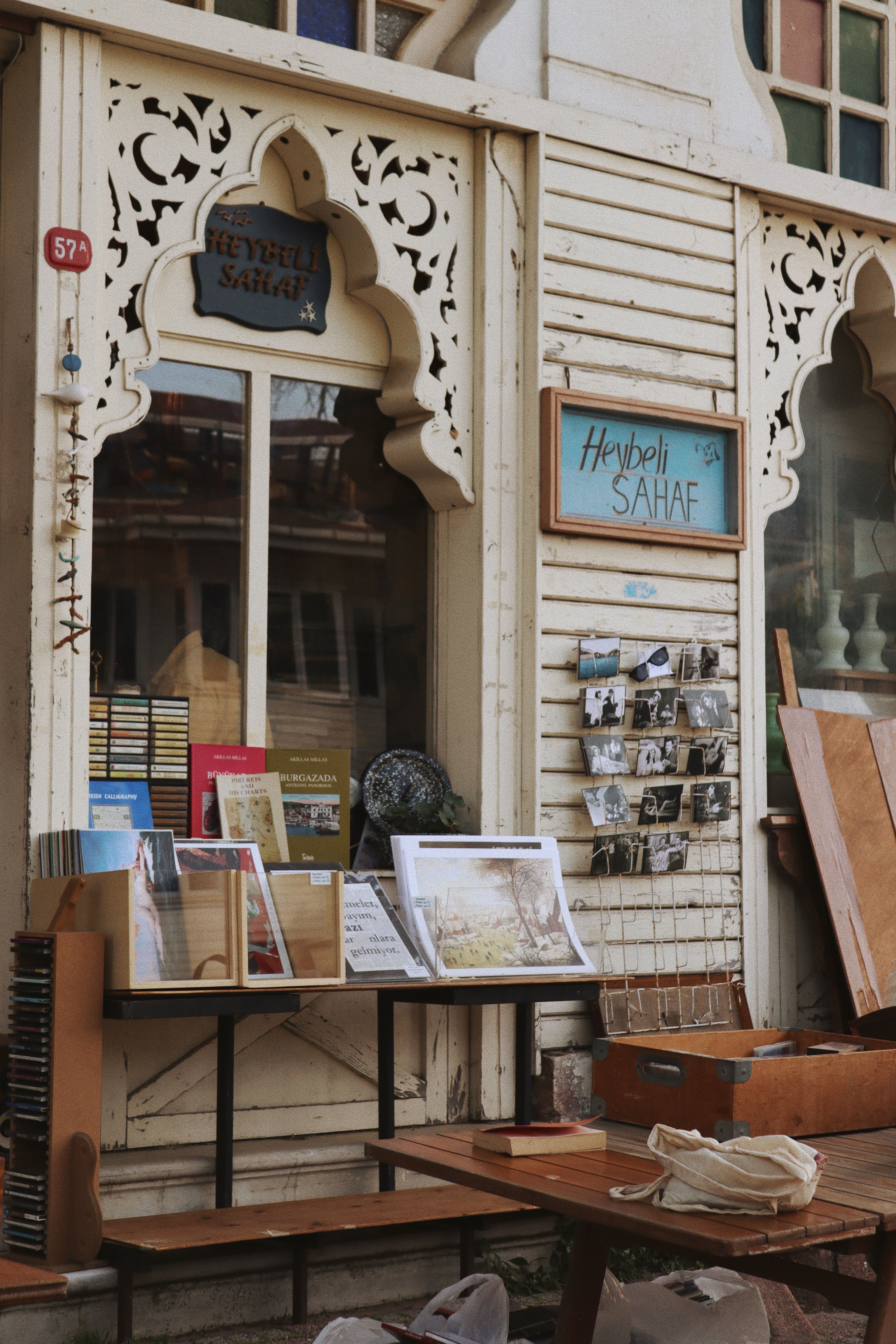 Vintage bookstore exterior with books and postcards displayed in Istanbul, Türkiye.