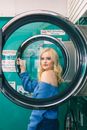 Woman in Blue Off-shoulder Long-sleeved Shirt Standing Beside Washing Machine
