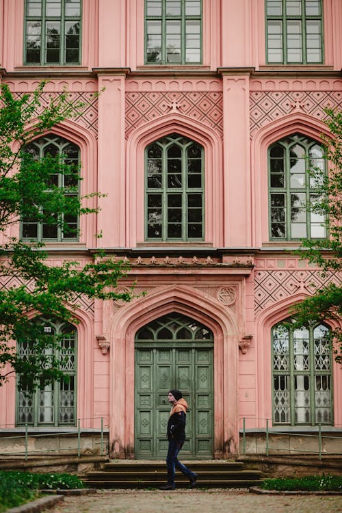 Free Pink Facade with Arched Door and Windows Stock Photo