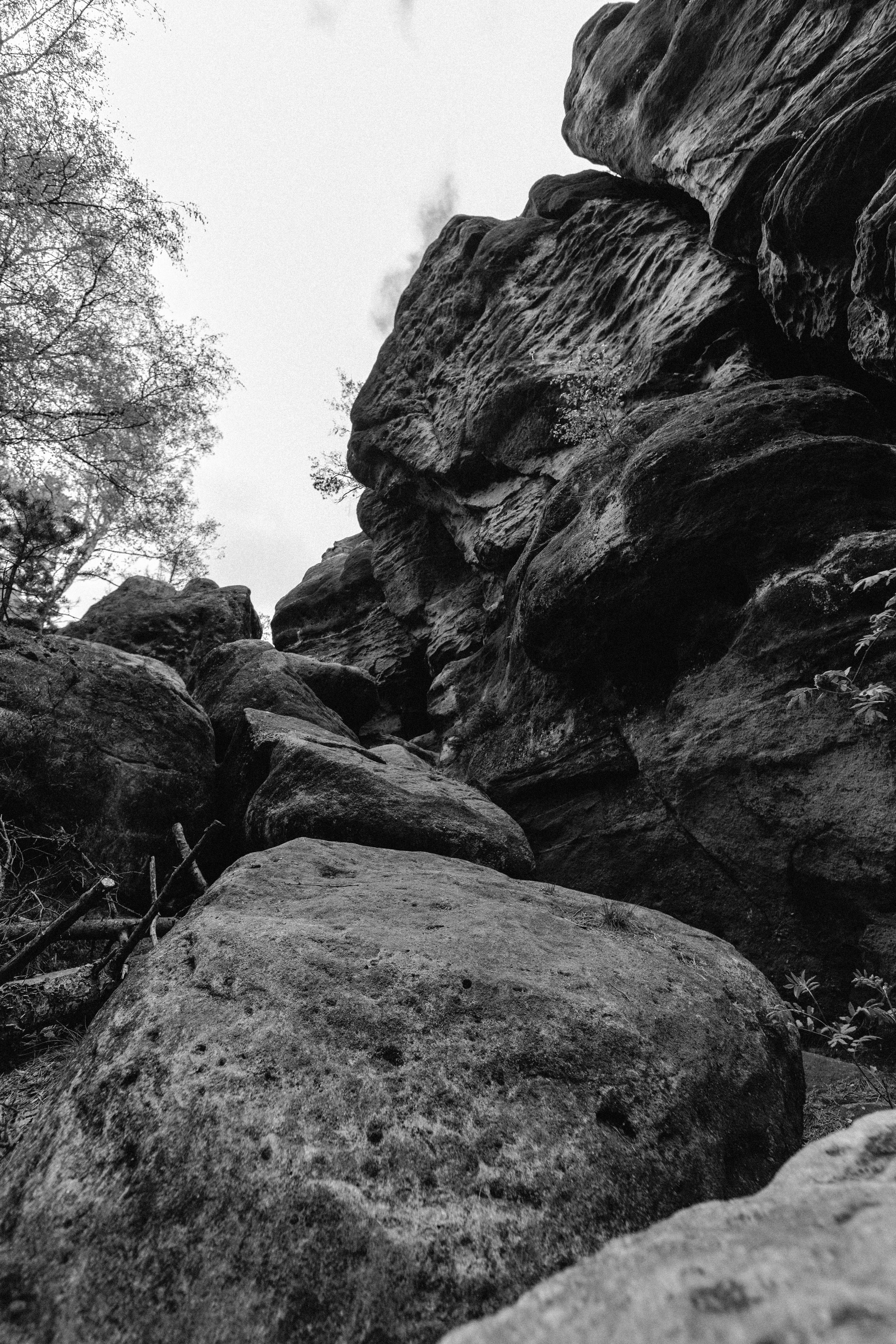 Black and white photo of a rocky cliff in Zittau Mountains, Germany.