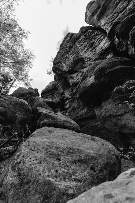 Black and white photo of a rocky cliff in Zittau Mountains, Germany.