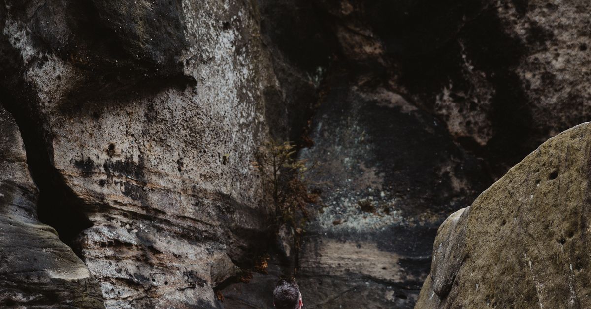 Look At Rocks Man Looking at Rock Formation · Free Stock Photo