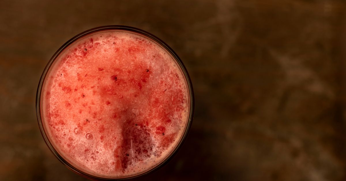 Top view of a refreshing blended fruit cocktail in a glass, perfect for summer gatherings.