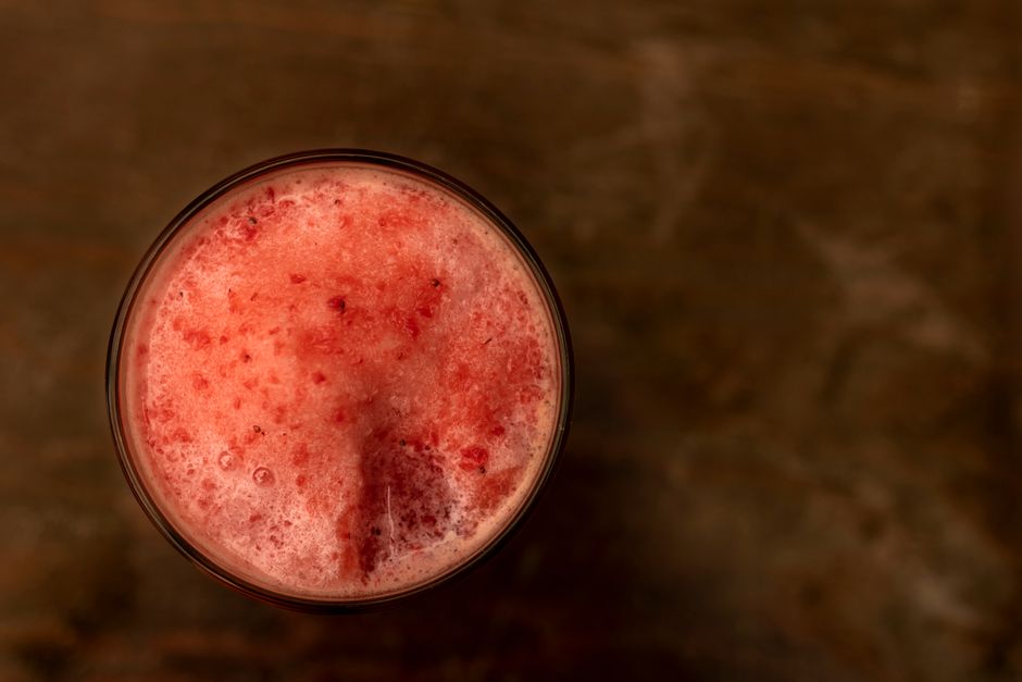 Top view of a refreshing blended fruit cocktail in a glass, perfect for summer gatherings.