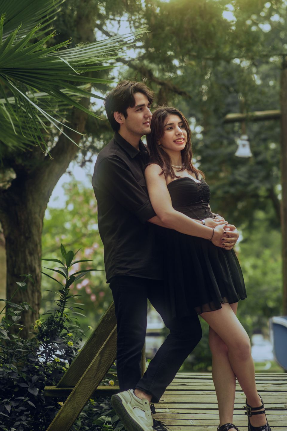 A couple embracing among green plants