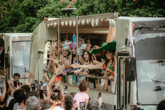 Vibrant carnival parade with people in costumes on trucks, bringing festive joy in Adana, Türkiye.