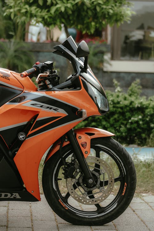 A close up of an orange and black motorcycle