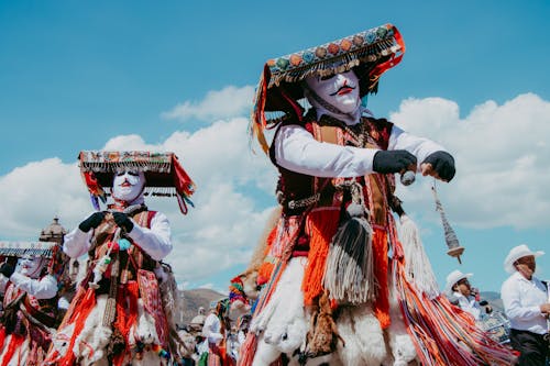 Dancers in Traditional Costumes and Masks Celebrating in Peru 
