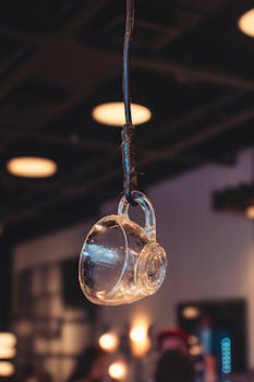 A hanging glass cup in a cafe with warm lighting creates a cozy urban feel.