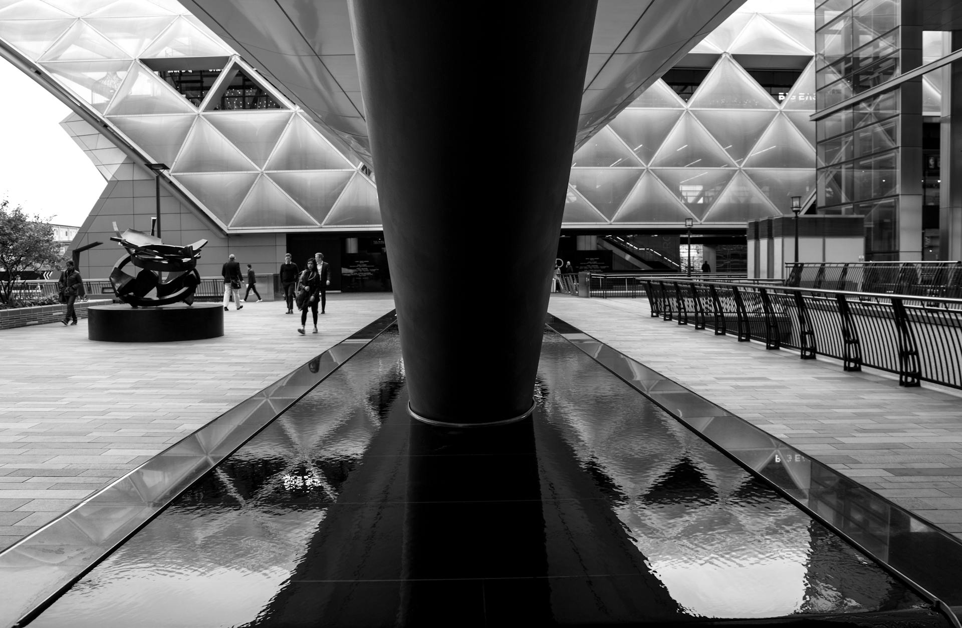 Contemporary architectural scene in Greater London with reflective water feature.