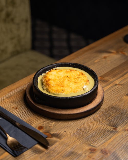 A small dish of food sitting on a wooden table