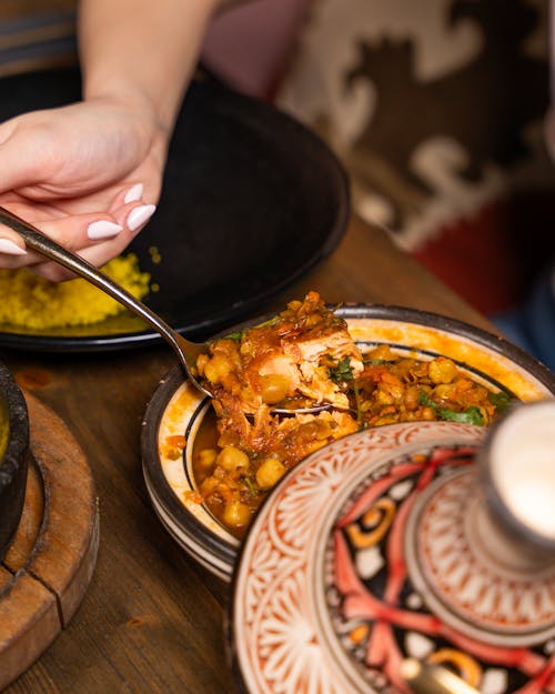 A person is eating food from a plate