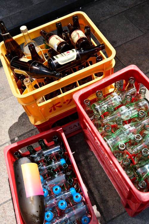 A crate of beer bottles on the sidewalk