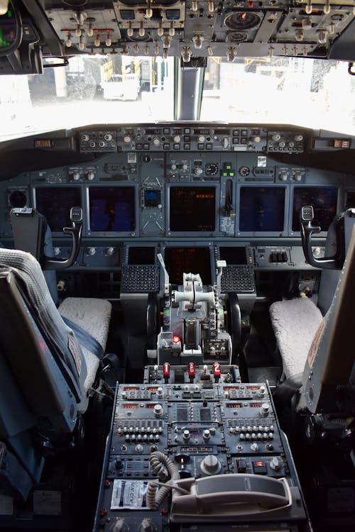 The cockpit of an airplane with many different controls