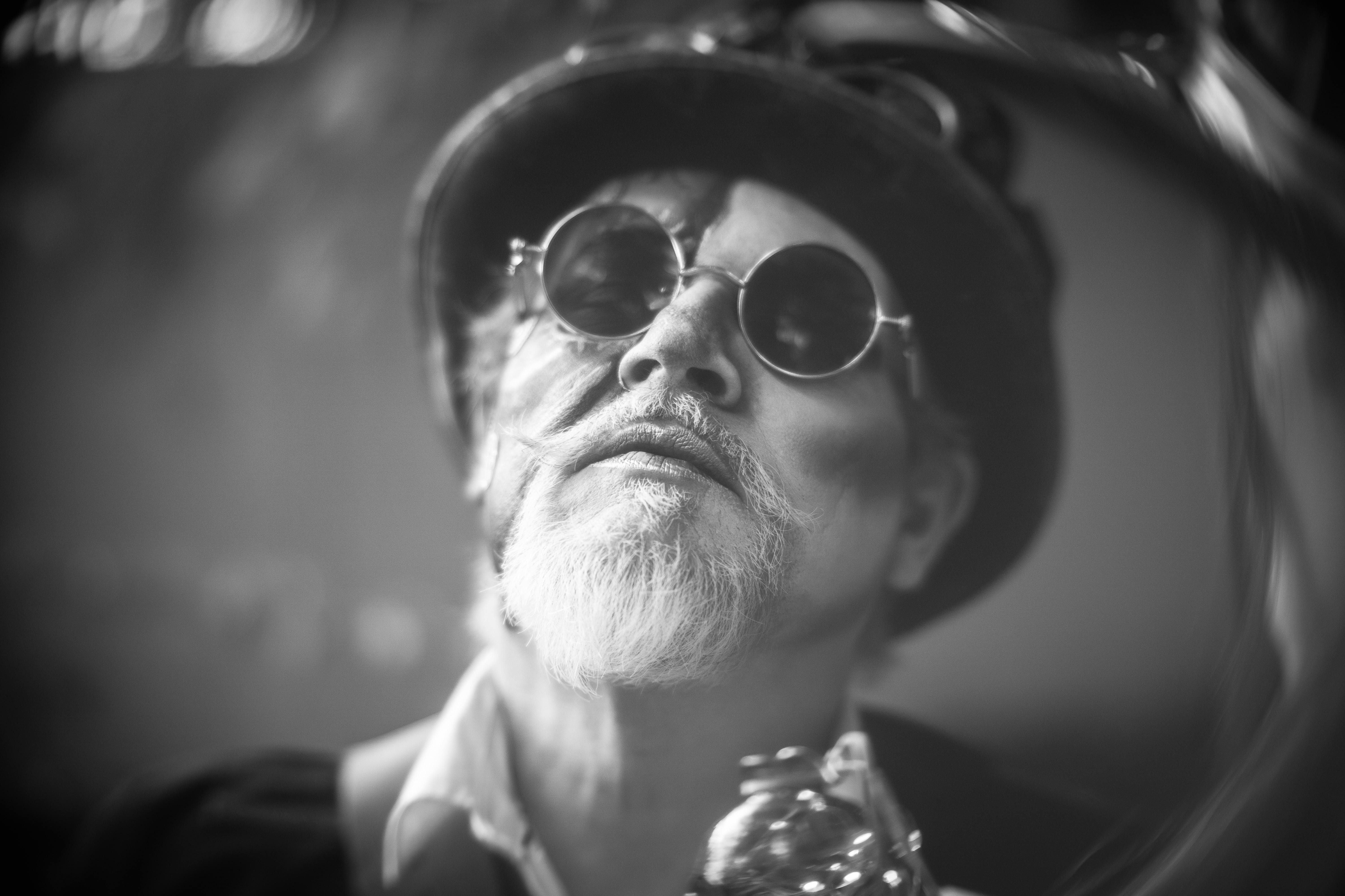 A man with a beard and glasses is looking at the camera