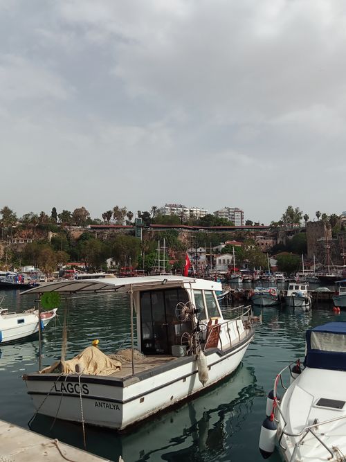 Free Charming scene of moored boats in Antalya harbor with overcast sky, capturing the tranquil coastal atmosphere. Stock Photo