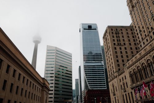 Free Toronto skyline featuring CN Tower amidst fog, showcasing modern architecture. Stock Photo