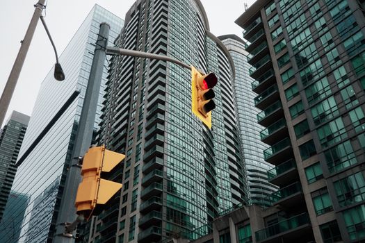 A vibrant city scene featuring skyscrapers and a traffic light.