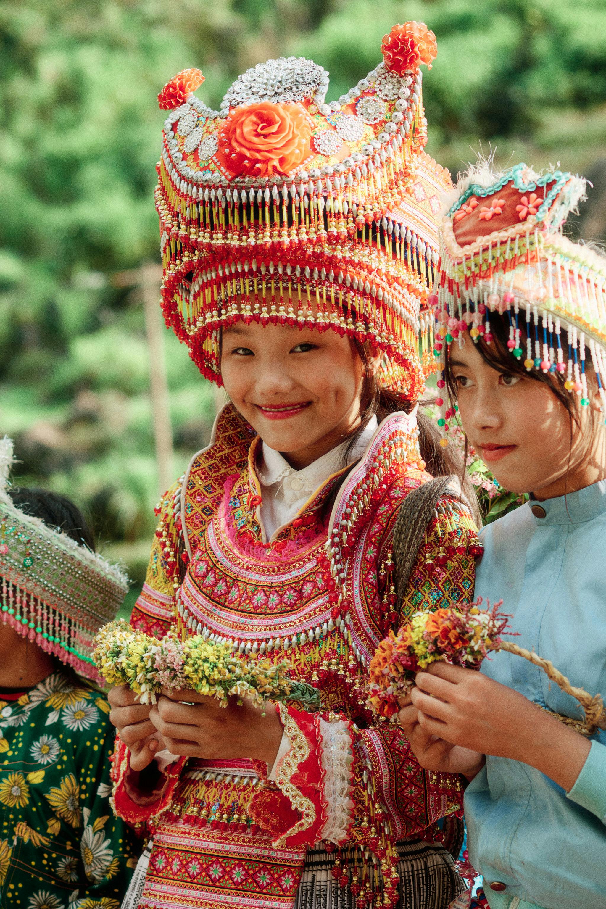 people wearing traditional costumes at a ceremony