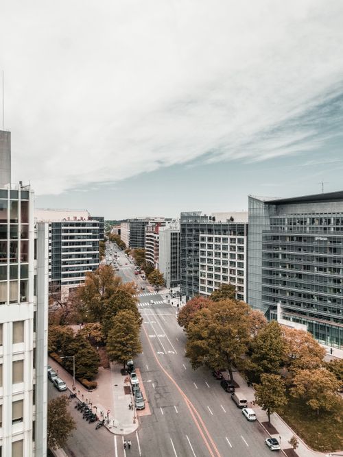 Free Aerial view of a modern cityscape featuring high-rise buildings and bustling streets. Stock Photo