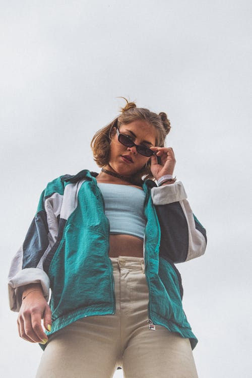 Low Angle Shot of Woman in Black Sunglasses Looking Down