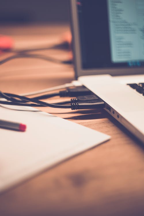 Free Macbook Pro on Brown Wooden Table Stock Photo