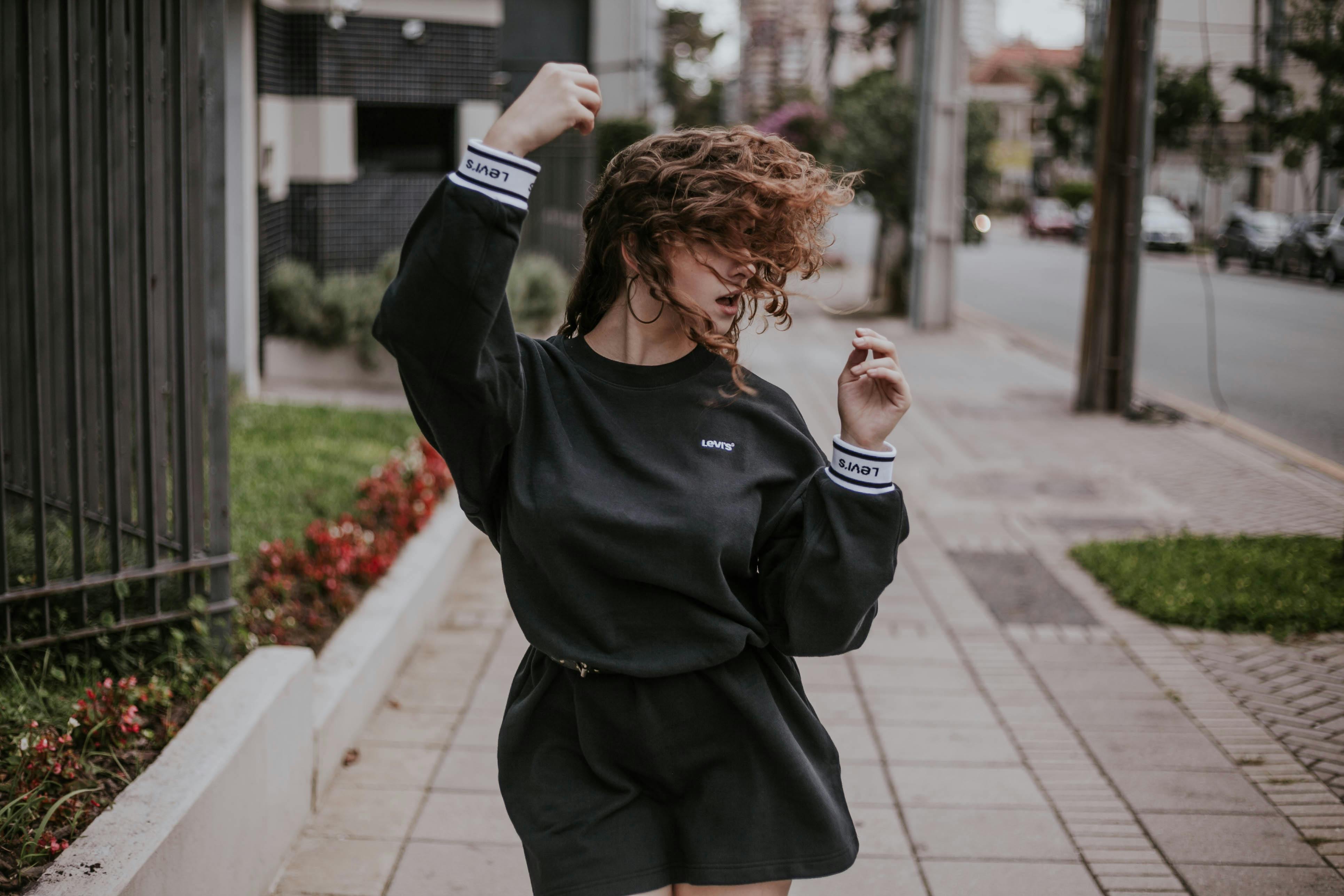 Woman Wearing Long Sleeve Shirt Walking On Street · Free Stock Photo