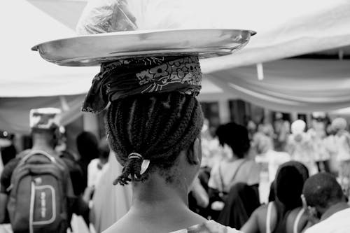woman carrying tray on her head