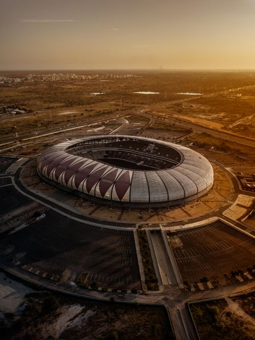 Free Aerial shot of Estádio 11 de Novembro in Luanda, Angola during sunset, capturing its modern architecture. Stock Photo