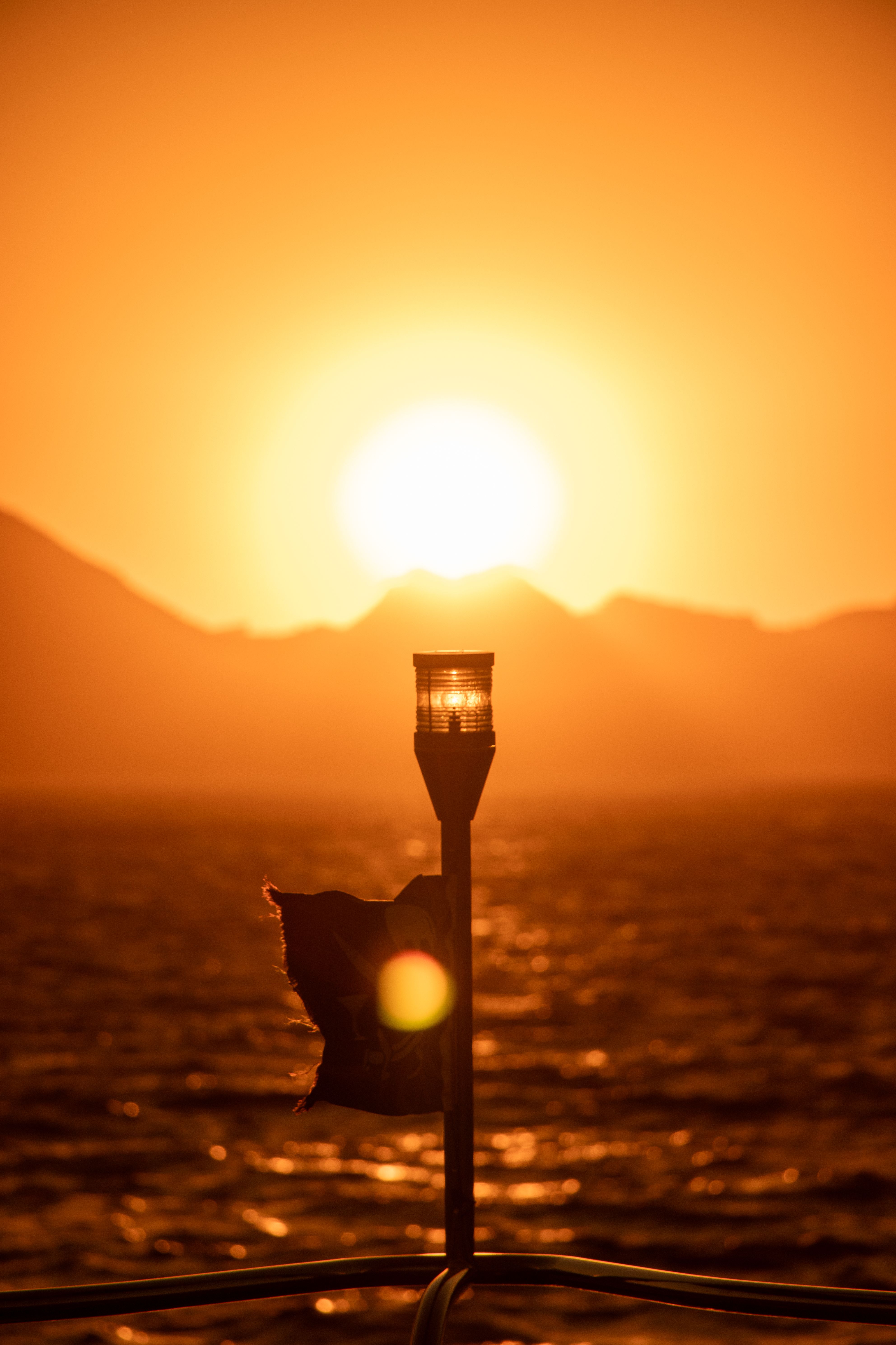 A lamp post on a boat at sunset · Free Stock Photo