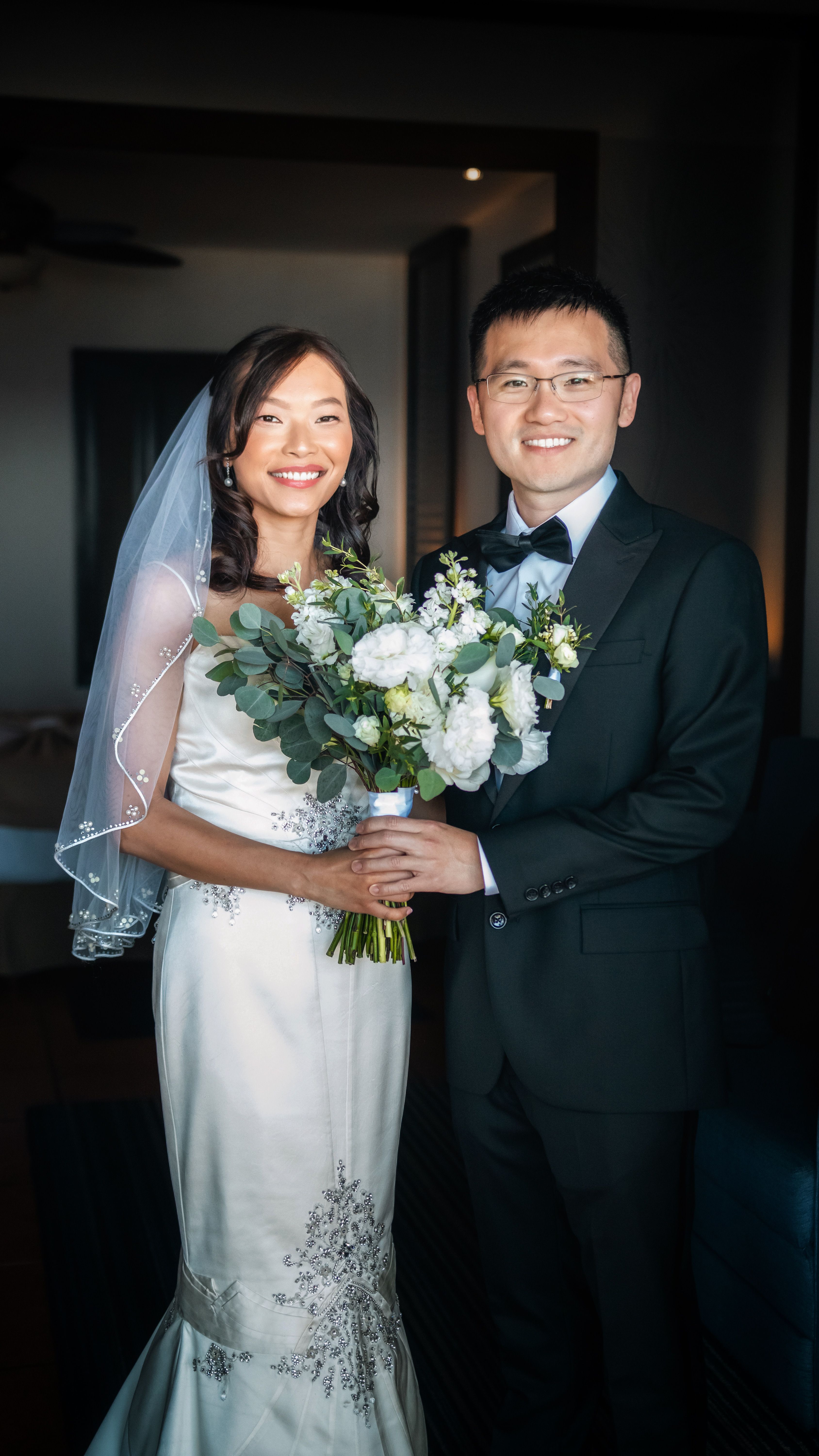 Elegant wedding portrait of a bride and groom posing indoors in Cabo San Lucas.