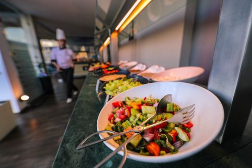 Free A colorful salad on a buffet table in a restaurant, emphasizing freshness and variety. Stock Photo