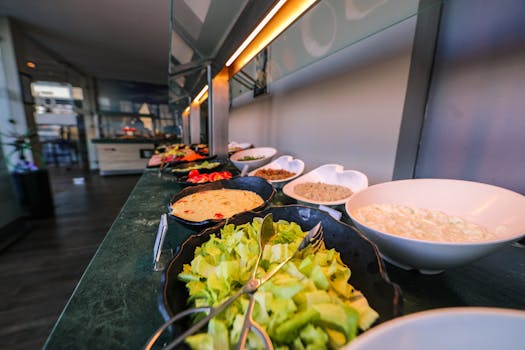 A colorful buffet with various fresh salads and dishes in bowls, perfect for a healthy meal.