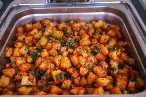 A roasting tray of herbed potatoes — photo by Zak Chapman on Pexels